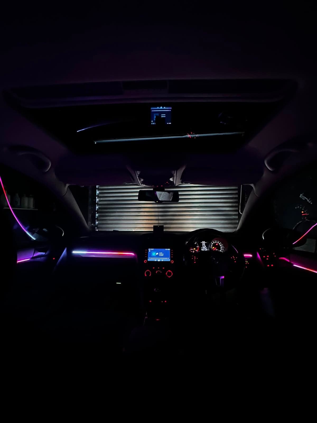Multi-zone ambient lighting lit across a car's cabin at night