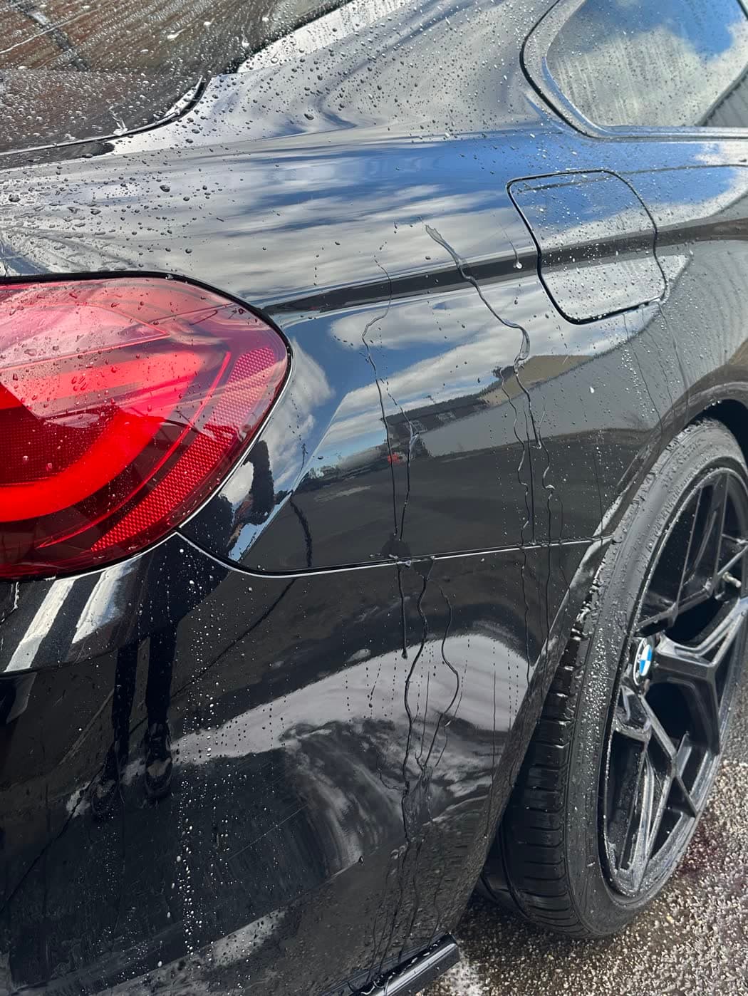 The same car after washing, rinsed clean with the paint gleaming
