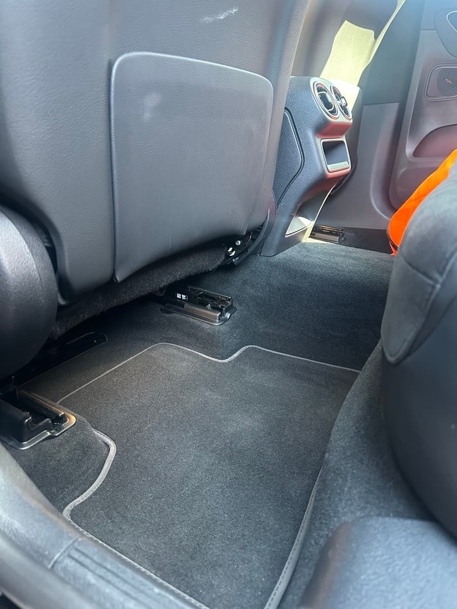 The same rear footwell vacuumed, the mats clean