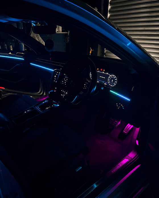 Car footwell and dashboard lit with ambient lighting